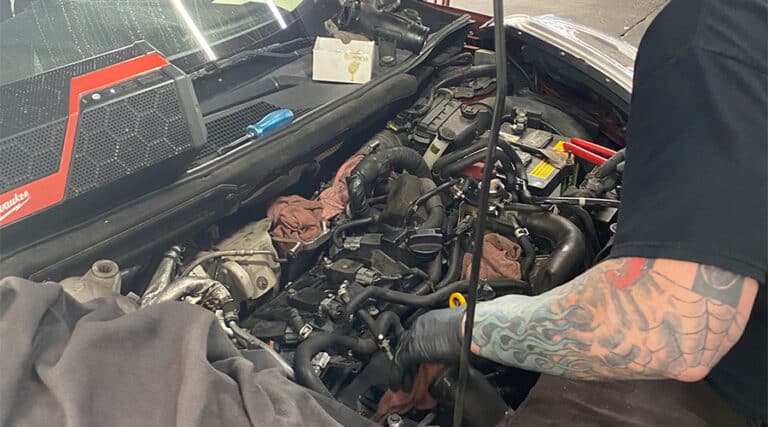 Maxi Auto Repair and Service’s mechanic checking the condition of a car under the hood. Concept image of “Common Causes of Poor Car Driveability” | Maxi Auto Repair and Service - Beach Boulevard in Jacksonville, FL.