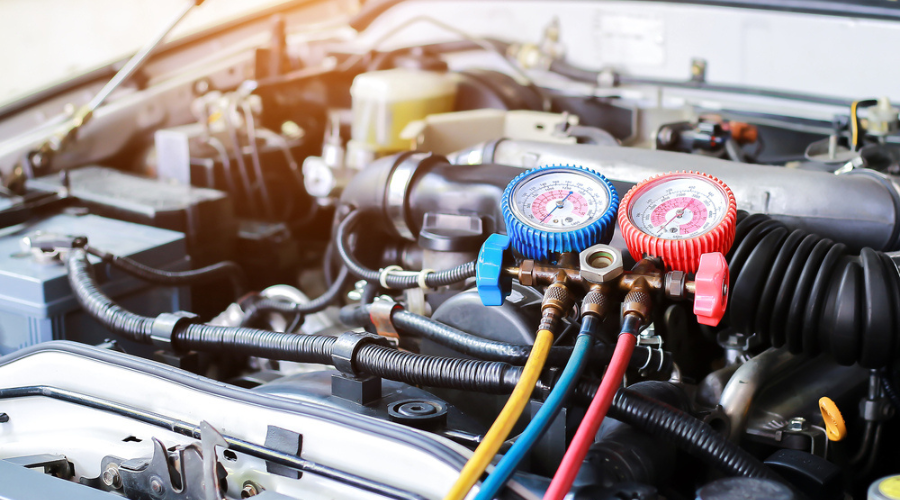 Car AC Repair in Jacksonville, FL by Maxi Auto Repair: Car engine bay with professional AC diagnostic tools attached, emphasizing the need for expert AC repair and maintenance to ensure optimal cooling performance during hot weather.