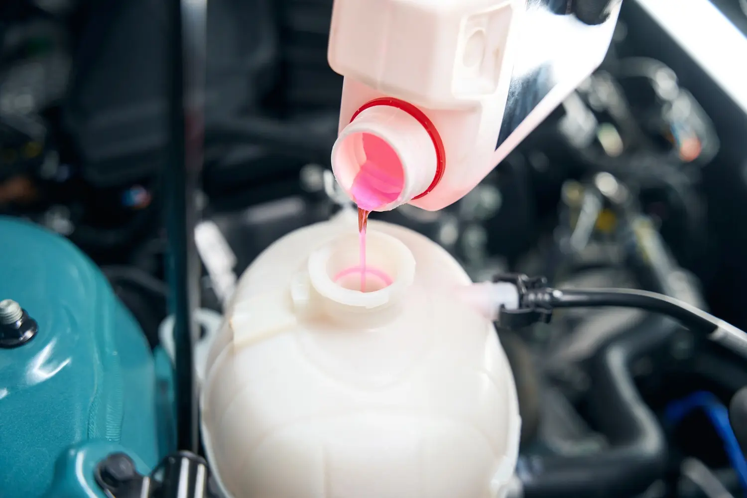 close up photo of mechanic changing antifreeze flu utc